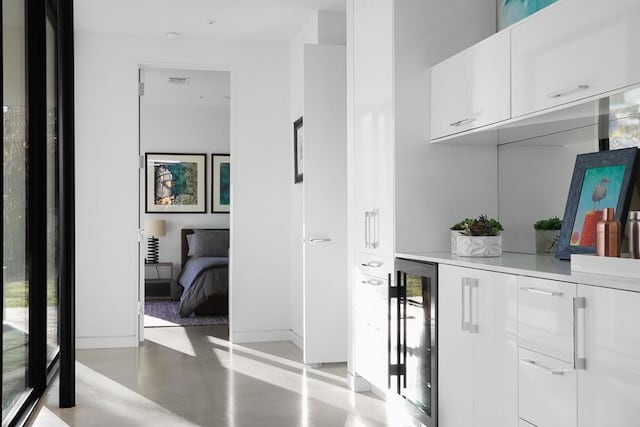 4607 Laurel Canyon Dr, Austin, TX 78731 - corridor featuring wine cooler and concrete flooring