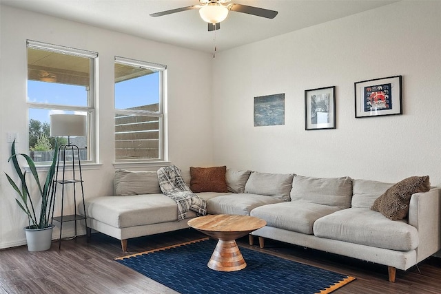 living room featuring a ceiling fan, wood finished floors, and baseboards