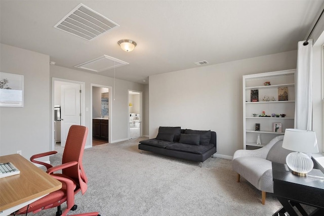 office space featuring attic access, carpet floors, and baseboards