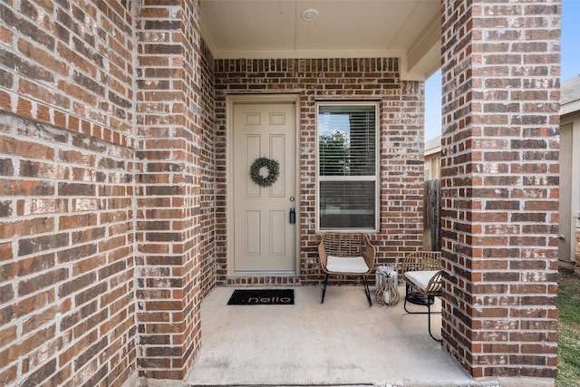 property entrance with brick siding