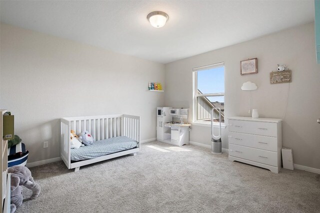 carpeted bedroom featuring baseboards
