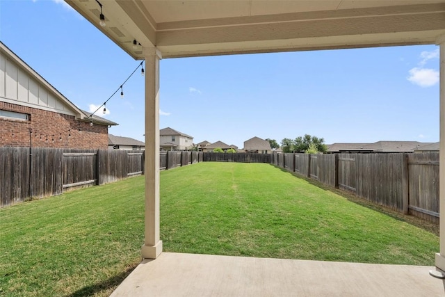 view of yard featuring a patio and a residential view