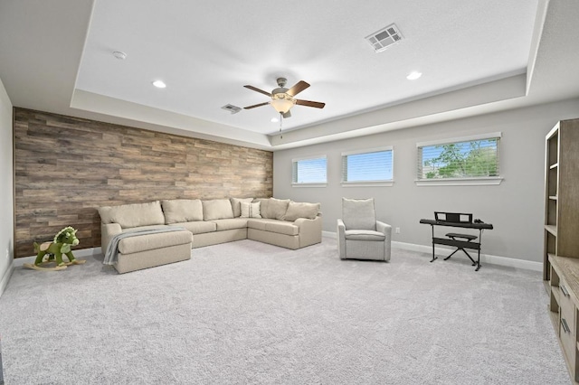 carpeted living area featuring baseboards, a ceiling fan, visible vents, and recessed lighting