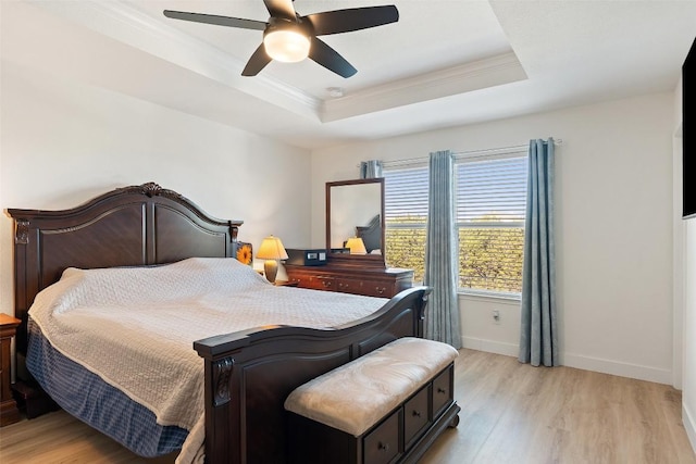 11604 Gaelic Dr, Austin, TX 78754 - bedroom featuring light wood-type flooring, crown molding, a tray ceiling, and ceiling fan
