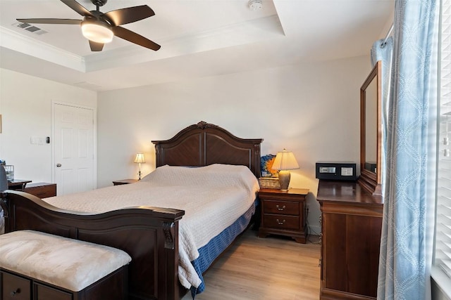 11604 Gaelic Dr, Austin, TX 78754 - bedroom with a tray ceiling, light wood-style flooring, crown molding, and a ceiling fan