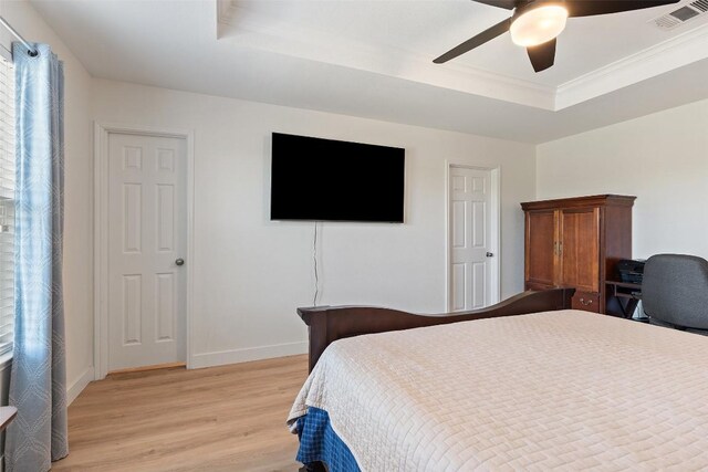 11604 Gaelic Dr, Austin, TX 78754 - bedroom with a tray ceiling, light wood-style floors, ceiling fan, and crown molding