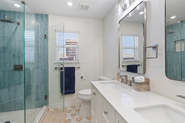11604 Gaelic Dr, Austin, TX 78754 - bathroom featuring a shower stall, double vanity, tile patterned flooring, and recessed lighting