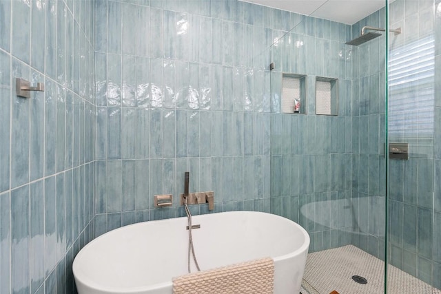 11604 Gaelic Dr, Austin, TX 78754 - bathroom with tile walls, a freestanding bath, and tiled shower