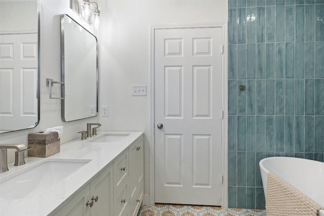 11604 Gaelic Dr, Austin, TX 78754 - bathroom featuring a freestanding tub, double vanity, and tile patterned floors
