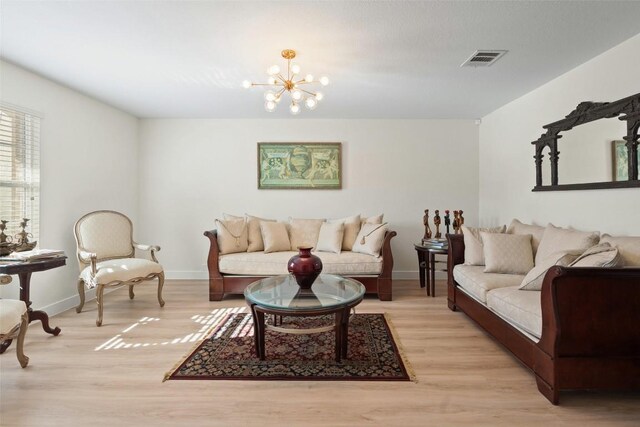 11604 Gaelic Dr, Austin, TX 78754 - living room featuring light wood-type flooring and a chandelier