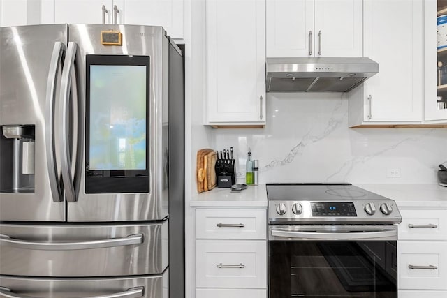11604 Gaelic Dr, Austin, TX 78754 - kitchen with stainless steel appliances, under cabinet range hood, light countertops, white cabinets, and decorative backsplash