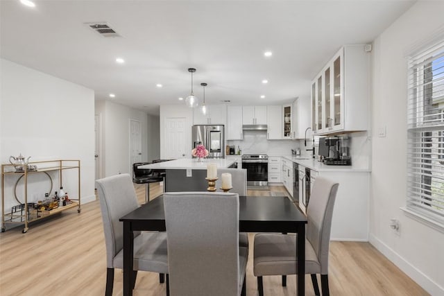 11604 Gaelic Dr, Austin, TX 78754 - dining room with light wood-style floors and recessed lighting