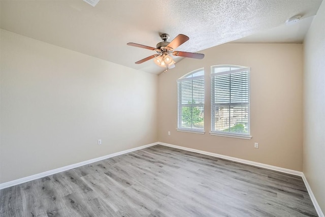 1432 Blake St, Leander, TX 78641 - spare room featuring a smoke detector, wood finished floors, a ceiling fan, lofted ceiling, and a textured ceiling