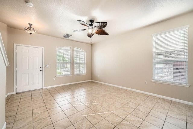1432 Blake St, Leander, TX 78641 - spare room featuring ceiling fan, a smoke detector, light tile patterned floors, a textured ceiling, and baseboards