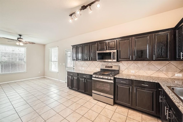 1432 Blake St, Leander, TX 78641 - kitchen featuring stainless steel appliances, a ceiling fan, light tile patterned flooring, backsplash, and light stone countertops