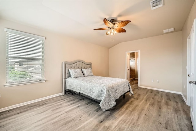 1432 Blake St, Leander, TX 78641 - bedroom featuring wood finished floors, vaulted ceiling, a ceiling fan, and connected bathroom