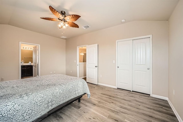 1432 Blake St, Leander, TX 78641 - bedroom with lofted ceiling, light wood-type flooring, baseboards, a closet, and connected bathroom