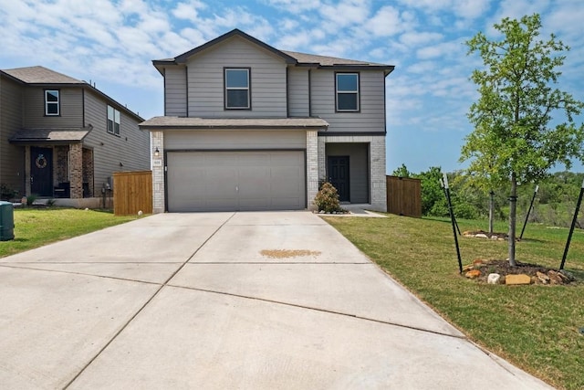 traditional-style house with an attached garage, a front yard, concrete driveway, and fence