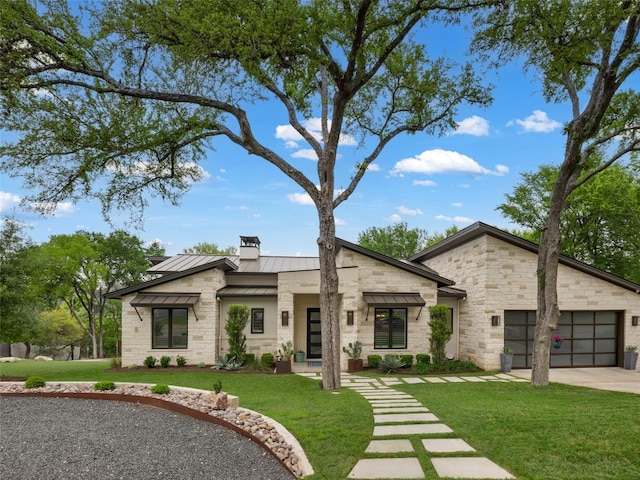 9806 Inca Ln, Austin, TX 78733 - modern home with a standing seam roof, stone siding, a chimney, and driveway