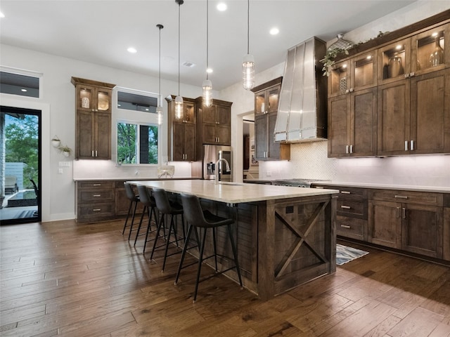 9806 Inca Ln, Austin, TX 78733 - kitchen featuring wall chimney range hood, dark wood-type flooring, plenty of natural light, light countertops, and recessed lighting