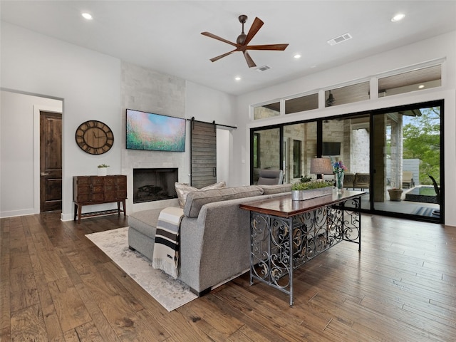 9806 Inca Ln, Austin, TX 78733 - living room featuring recessed lighting, a ceiling fan, wood-type flooring, a fireplace, and a barn door