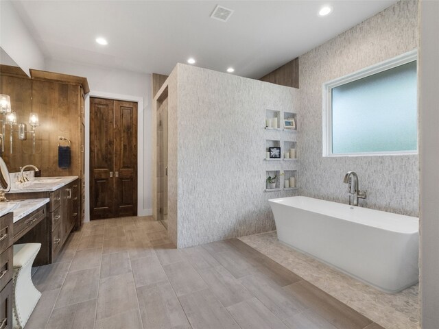 9806 Inca Ln, Austin, TX 78733 - bathroom with a freestanding bath, vanity, a shower stall, recessed lighting, and wood finished floors