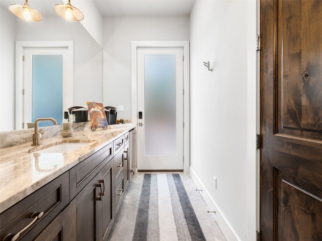 9806 Inca Ln, Austin, TX 78733 - bathroom with double vanity and baseboards