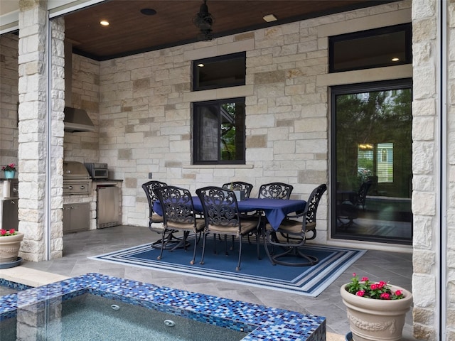 9806 Inca Ln, Austin, TX 78733 - view of patio with an outdoor kitchen, outdoor dining space, and an in-ground hot tub