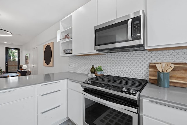 705 N Bluff Dr Unit 14, Austin, TX 78745 - kitchen with appliances with stainless steel finishes, white cabinetry, open shelves, and decorative backsplash
