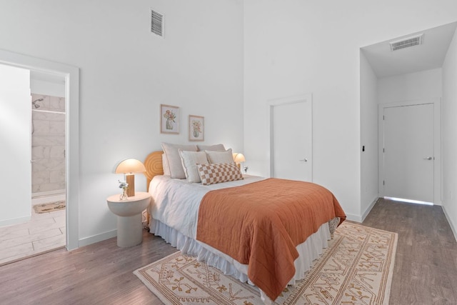 705 N Bluff Dr Unit 14, Austin, TX 78745 - bedroom with wood finished floors and ensuite bathroom
