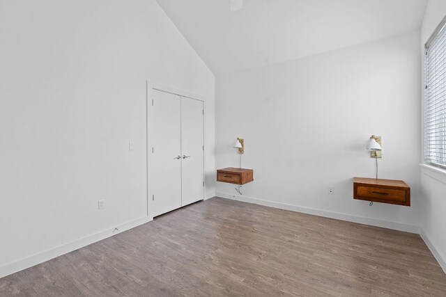 705 N Bluff Dr Unit 14, Austin, TX 78745 - unfurnished bedroom featuring vaulted ceiling, wood finished floors, a closet, and ceiling fan