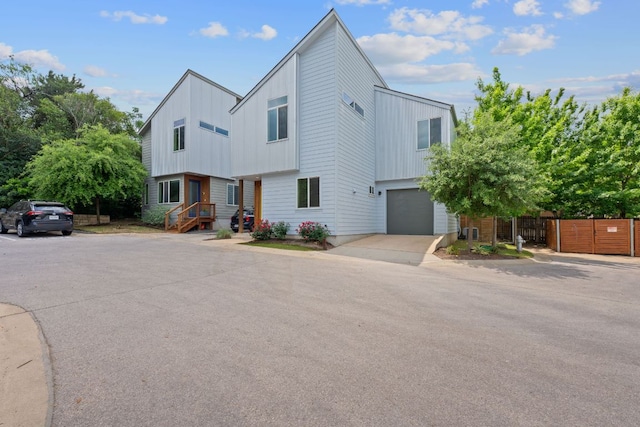 705 N Bluff Dr Unit 14, Austin, TX 78745 - view of front of home featuring board and batten siding, a garage, and driveway