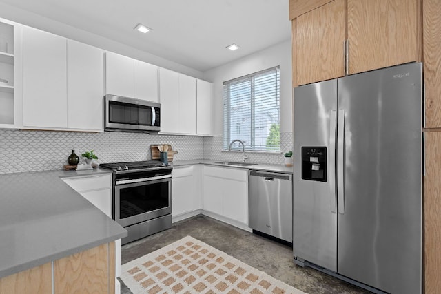 705 N Bluff Dr Unit 14, Austin, TX 78745 - kitchen featuring appliances with stainless steel finishes, concrete floors, decorative backsplash, and light countertops