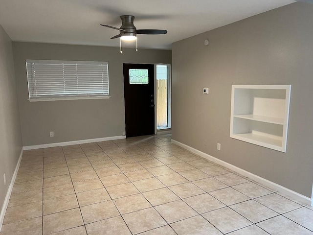 entrance foyer with light tile patterned flooring, baseboards, and ceiling fan