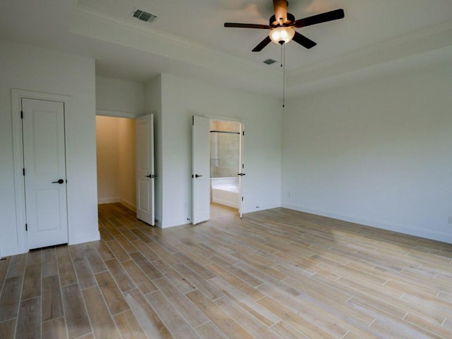 1705 Cayuga St, Leander, TX 78641 - empty room with a raised ceiling, ceiling fan, light wood-type flooring, crown molding, and baseboards