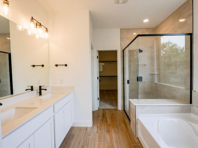 1705 Cayuga St, Leander, TX 78641 - full bath featuring a stall shower, wood finished floors, a garden tub, double vanity, and a walk in closet