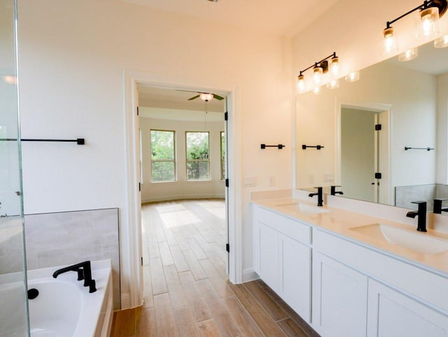 1705 Cayuga St, Leander, TX 78641 - full bathroom featuring double vanity, a bath, wood finished floors, and ceiling fan