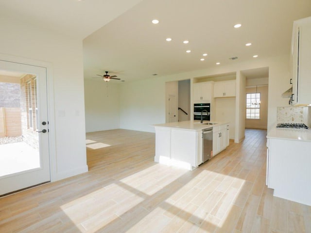 1705 Cayuga St, Leander, TX 78641 - kitchen with dishwasher, white cabinetry, gas cooktop, a sink, and ceiling fan