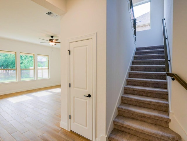 1705 Cayuga St, Leander, TX 78641 - stairs featuring a ceiling fan, baseboards, and wood finished floors