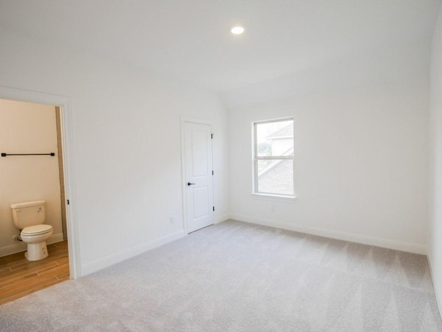 1705 Cayuga St, Leander, TX 78641 - unfurnished bedroom featuring light carpet, ensuite bath, recessed lighting, and lofted ceiling