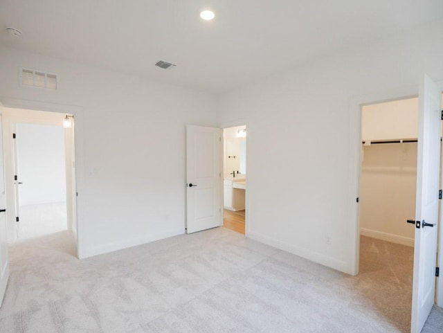 1705 Cayuga St, Leander, TX 78641 - unfurnished bedroom featuring light carpet, a spacious closet, baseboards, recessed lighting, and a closet