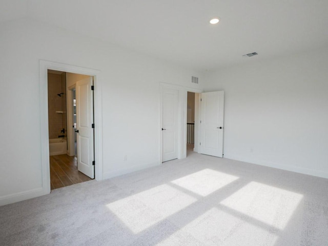 1705 Cayuga St, Leander, TX 78641 - unfurnished bedroom with carpet floors, recessed lighting, and ensuite bath