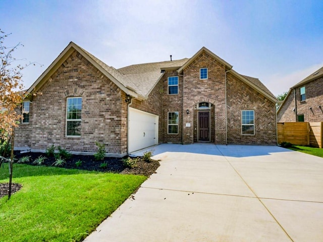 1705 Cayuga St, Leander, TX 78641 - traditional-style home with driveway, brick siding, and an attached garage