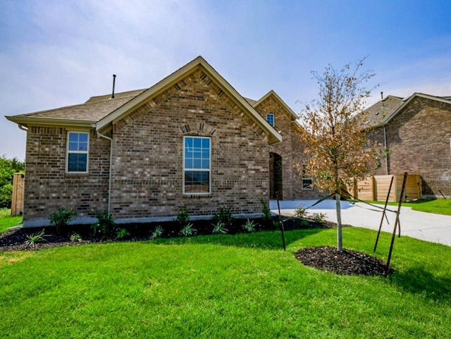 1705 Cayuga St, Leander, TX 78641 - view of front of property with a front lawn, brick siding, and concrete driveway