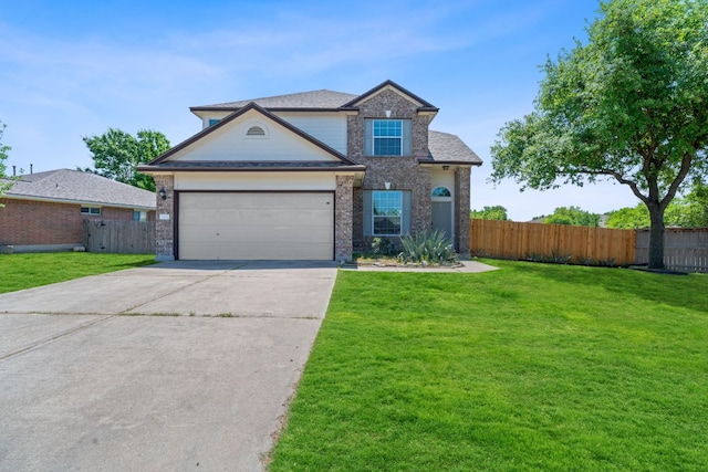 traditional-style home featuring concrete driveway, an attached garage, fence, and a front yard