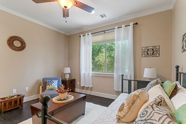 living area with baseboards, crown molding, wood finished floors, and visible vents