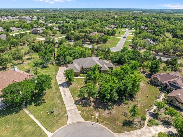 birds eye view of property with a view of trees and a residential view