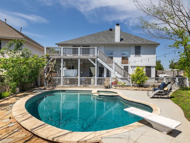16019 Dark Ln, Austin, TX 78717 - view of swimming pool with stairway, a wooden deck, a patio area, a pool with connected hot tub, and a diving board