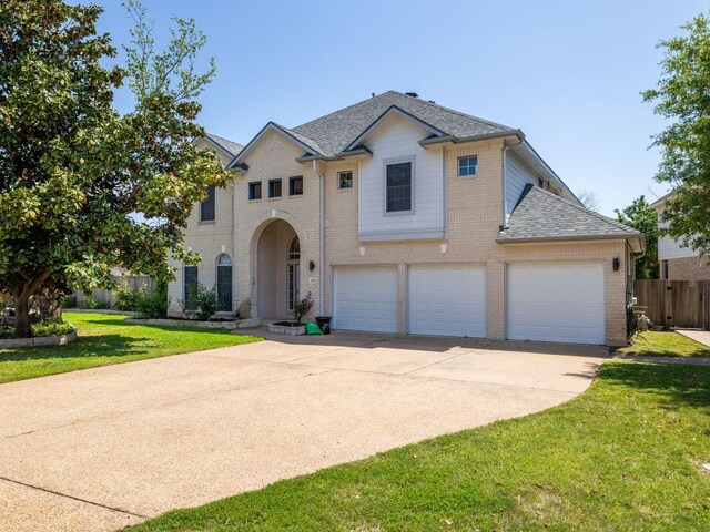 16019 Dark Ln, Austin, TX 78717 - traditional home featuring brick siding, driveway, an attached garage, and a shingled roof