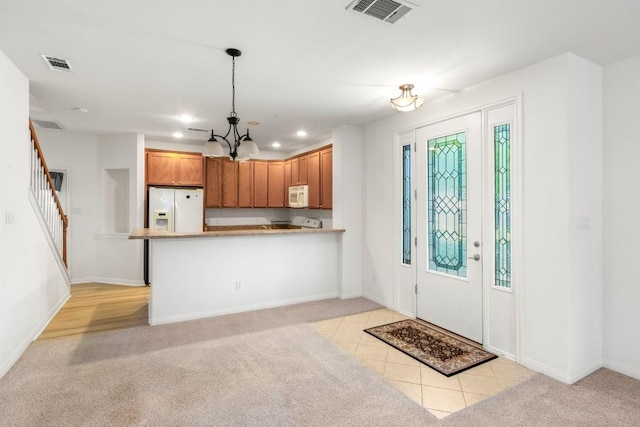 kitchen with visible vents, light carpet, white appliances, and recessed lighting